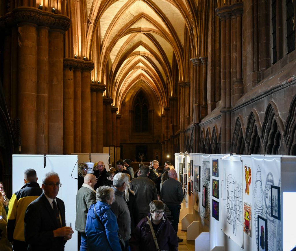 A large grand Cathedral hall with an exhibition of artwork on show